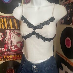 White small knit top with crossed black lace detailing